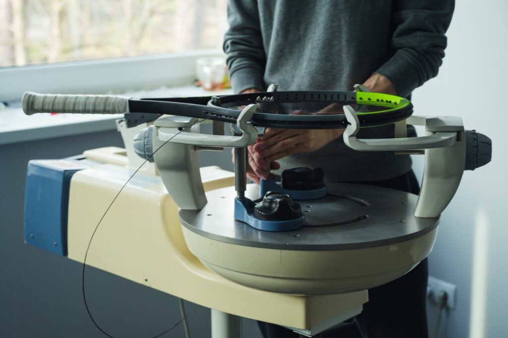 How to String a Tennis Racket: Mount the racket on the stringing machine